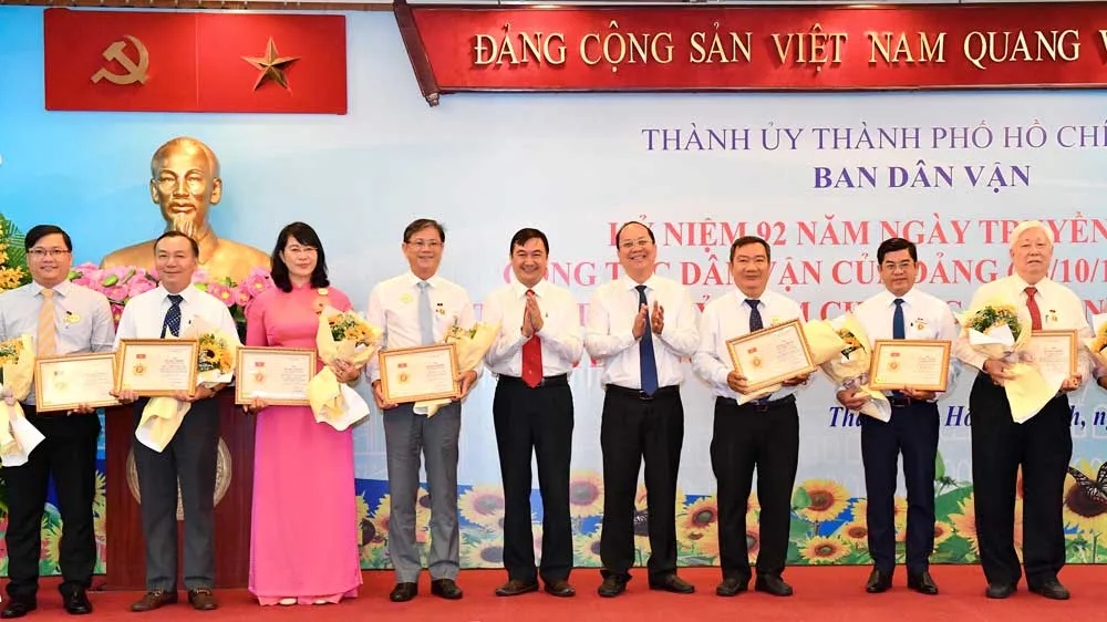 Phó Bí thư Thành ủy TPHCM Nguyễn Hồ Hải tặng kỷ niệm chương “Vì sự nghiệp dân vận”. Ảnh: VIỆT DŨNG