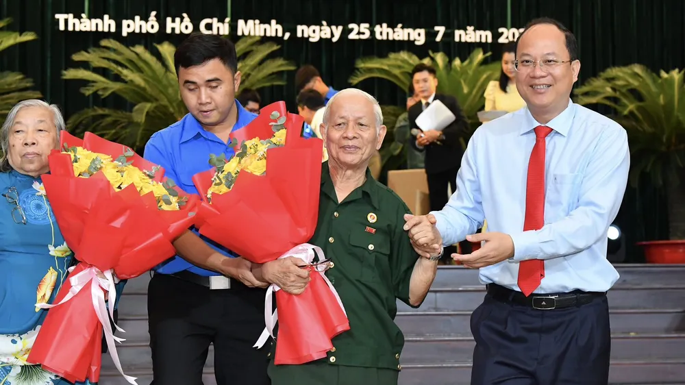 Phó Bí thư Thành ủy TPHCM Nguyễn Hồ Hải cùng các đại biểu người có công. Ảnh: VIỆT DŨNG.
