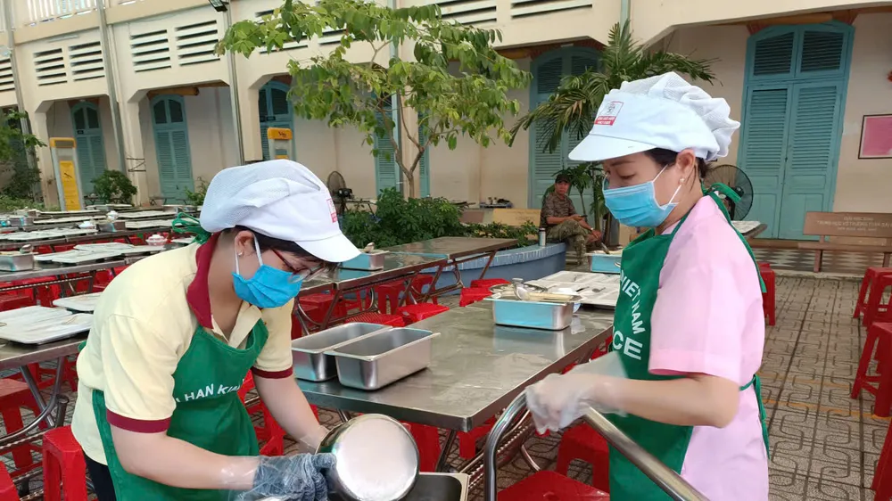 Nhân viên phục vụ bán trú phân chia suất ăn tại Trường THCS Võ Trường Toản (phường Sài Gòn). Ảnh minh họa.