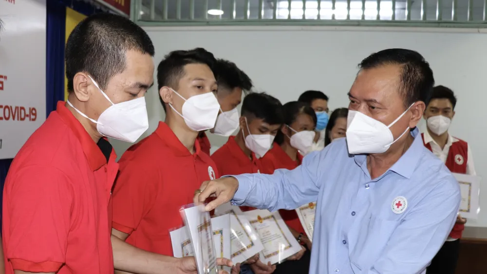 Chủ tịch Hội Chữ thập đỏ TPHCM Trần Trường Sơn trao giấy khen cho tình nguyện viên