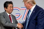 U.S President Donald Trump, right, and Japanese Prime Minister Shinzo Abe shake hands following a news conference at the Group of Seven summit in France. © AP