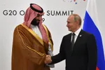 Vladimir Putin, right, shakes hands with Mohammed bin Salman on the sidelines of the G20 Summit in Osaka in 2019.Photographer: Yuri Kadobnov/AFP via Getty Images