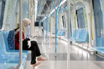 A woman wearing protective mask and gloves seen on a Mass Rapid Transit train during a movement control order in Kuala Lumpur on Sunday. © Reuters