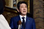 Japanese Prime Minister Shinzo Abe speaks to reporters at the prime minister's office in Tokyo after a phone call with International Olympic Committee President Thomas Bach on Tuesday. (Photo by Arisa Moriyama)