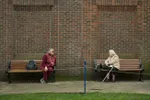Two women keep 6 feet (1.8 meters) apart as they speak to each other from adjacent park benches amidst the novel coronavirus COVID-19 pandemic, in the centre of York, northern England on March 19, 2020. (Image: © OLI SCARFF/AFP via Getty Images)