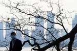 A man wearing a face mask strolls along the Yangtze River in Wuhan, Hubei Province, epicenter of the viral outbreak. © Reuters