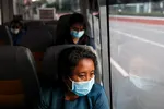 Medical workers ride a shuttle bus in Manila: Thousands leave the country every year to work overseas. © Reuters