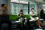 Social distancing on a commuter train in Japan. Tokyoites will have to limit their time outside to 110 minutes per week, if a Yokohama City University professor's calculations are right. © AP