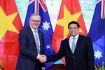 Australian Prime Minister Anthony Albanese, left, and Vietnamese Prime Minister Pham Minh Chinh, left, shake hands, ahead of their bilateral meeting in Hanoi, Vietnam, June 4, 2023. 
