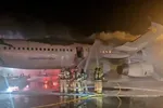 Lính cứu hỏa cố gắng dập tắt đám cháy trên máy bay Air Busan tại Sân bay quốc tế Gimhae ở Busan, Hàn Quốc, vào ngày 28/1/2025. (Ảnh: Yonhap)