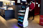 A robot delivers food to diners at a restaurant, following an outbreak of the novel coronavirus disease, in Shanghai. © Reuters