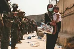 US troops guide an evacuee at Kabul’s international airport. Democrats are increasingly opposed to the use of force overseas in support of US interests © US Marine Corps/Sgt Isaiah Campbell/Reuters