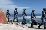 Soldiers of China's People's Liberation Army (PLA) Navy patrol Woody Island in the Paracel archipelago on January 29, 2016.