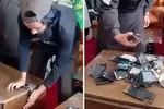 Điện thoại thông minh bị lực lượng Taliban phá hủy sau khi lệnh hạn chế sử dụng thiết bị này được ban hành. Ảnh cắt từ video: The Guardian