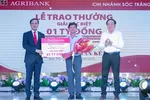 Đại diện lãnh đạo Agribank, Phó Tổng giám đốc Lê Hồng Phúc trao 1 tỷ đồng cho khách hàng trúng giải Đặc biệt.
