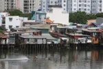 Nhiều hộ gia đình vẫn còn sinh sống trên và ven kênh Tẻ (quận 8). (Ảnh: Thanh Vũ/TTXVN)