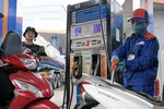 Khách hàng mua bán xăng, dầu tại một điểm kinh doanh xăng dầu của Petrolimex trên địa bàn Hà Nội. (Ảnh: Trần Việt /TTXVN) 