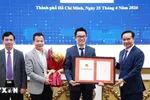 Ông Nguyễn Văn Được, Chủ tịch UBND TPHCM trao Giấy chứng nhận đầu tư cho đại diện doanh nghiệp. (Ảnh: TTXVN phát)