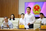 Thống đốc Ngân hàng Nhà nước Phạm Đức Ấn báo cáo tình hình hoạt động của ngành ngân hàng. (Ảnh: Dương Giang/TTXVN)