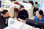 Cán bộ Thuế cơ sở 13 TPHCM hướng dẫn hộ kinh doanh thực hiện thủ tục thuế, trưa 31-7. Ảnh: KHÁNH CHÂU