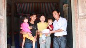 Ông Nguyễn Đức Tuấn, Phó Chủ tịch UBND xã Hồng Lộc (huyện Lộc Hà, tỉnh Hà Tĩnh) trao 35 triệu đồng của bạn đọc Báo SGGP cho gia đình vợ chồng anh Trung, chị Chi
