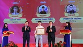 Đồng chí Võ Văn Thưởng, Ủy viên Bộ Chính trị, Bí thư Trung ương Đảng, Trưởng Ban Tuyên giáo Trung ương cùng Bộ trưởng Bộ Giáo dục và Đào tạo Phùng Xuân Nhạ trao giải Nhất cho thí sinh đạt giải. Ảnh: TTXVN