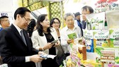 Visitors at the booth of startup businesses from Ben Tre Province. Photo by Huu Hiep