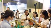 Visitors look at processed farm produce on display at the Vietnam International Exhibition on Processing, Packaging and Preserving Food and Agricultural Products held in HCM City. (Source: VNA)