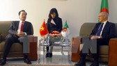 Vietnamese Minister of Construction Pham Hong Ha (L) at a meeting with Algerian Minister of Industry and Mines Youcef Yousfi (Photo: VNA)