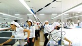 A hi-tech garment making line invested by Japanese Uniqlo Company in Vietnam (Photo: SGGP)