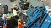HCM City sanitation workers load waste onto trucks that will carry it to landfills. Three closed landfill sites are planned to become golf courses, parks, and trade centres. — VNA/VNS