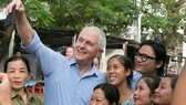Australian Prime Minister Malcolm Turnbull takes a selfie with local residents in Danang