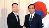 Paik Un-gyu, South Korean minister of trade, industry and energy (L), shakes hands with Thailand's Prime Minister Prayuth Chan-ocha (R) after their meeting in Bangkok on May 16, 2018, in this photo provided by the ministry. (Yonhap)