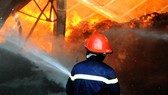 Chiến sĩ cảnh sát chữa cháy tiếp cận ngọn lửa lớn.