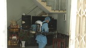 Members of the medical team spray disinfectant to sanitize house of the 418th case. (Phoro: SGGP)