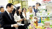 Visitors at the booth of startup businesses from Ben Tre Province. Photo by Huu Hiep
