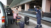Medical workers spray with Chloramin B disinfectant for passenger's luggage