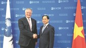 越南外交部长裴青山(右)会见OECD秘书长马蒂亚斯‧科尔曼。(图:越通社)