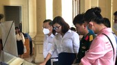 Visitors are using touchscreens to see the outline of the display areas at HCMC Museum