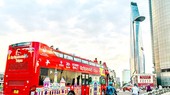 Visitors take hop-on hop-off bus tour in HCMC.