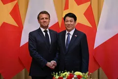 France's President Emmanuel Macron and Vietnam's President Luong Cuong shake hands during a meeting at the Presidential Palace in Hanoi on May 26, 2025. 