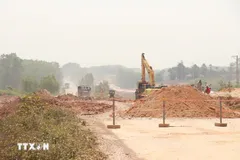 Các phương tiện thi công cao tốc Vạn Ninh-Cam Lộ qua huyện Vĩnh Linh (Quảng Trị). (Ảnh: Nguyên Lý/TTXVN)