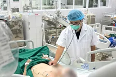 Bác sĩ Bệnh viện Bệnh Nhiệt đới Trung ương thăm khám cho bệnh nhân mắc cúm A. Ảnh: BVCC