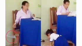 Cô giáo chấm bài xong rồi "thả" xuống nền gạch, học sinh chạy lên nhặt đem về. Ảnh cắt từ clip