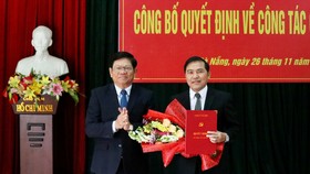 Ông Võ Công Trí, Phó Bí thư Thường trực Thành ủy Đà Nẵng trao quyết định và tặng hoa chúc mừng nhà báo Nguyễn Đức Nam