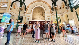 Foreign visitors admiring a period attraction