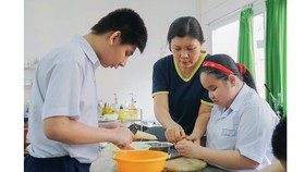 Cô Nguyễn Thị Kim Phượng hướng dẫn học trò những kỹ năng hàng ngày, giúp các em hòa nhập với cuộc sống. Ảnh: HOÀNG HÙNG