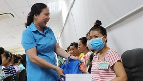 A representative of a trade union gives gift to pregnant workers (Photo:SGGP)