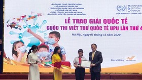 Deputy Minister of Information and Communications Pham Anh Tuan gives prize to Phan Hoang Phuong Nhi (Photo: SGGP)