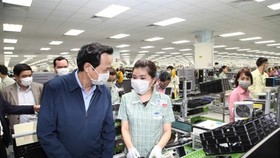 Minister of Labour, Invalids and Social Affairs Dao Ngoc Dung (L) visits Samsung Electronics Vietnam in Thai Nguyen province on February 13 (Photo: vtc.vn)
